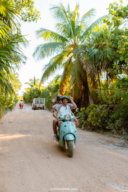 2 people driving a motorbike in sian Ka'an Bio Reserve Yucatan Mexico