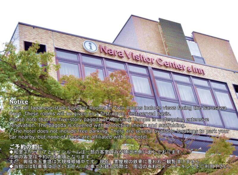 Exterior view of Visitor Inn Nara & Center with informational notice in English and Japanese about room views, ongoing renovations, and parking availability.