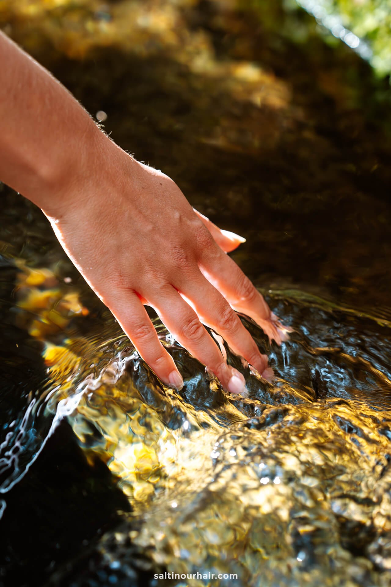 hand in fresh water of a levada madeira