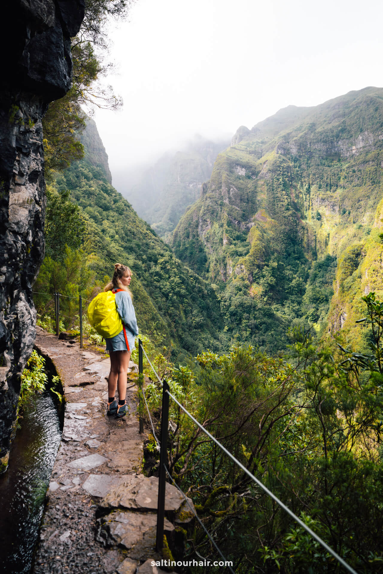 girl on trail to Levada do Caldeirao Verde with view on valley madeira