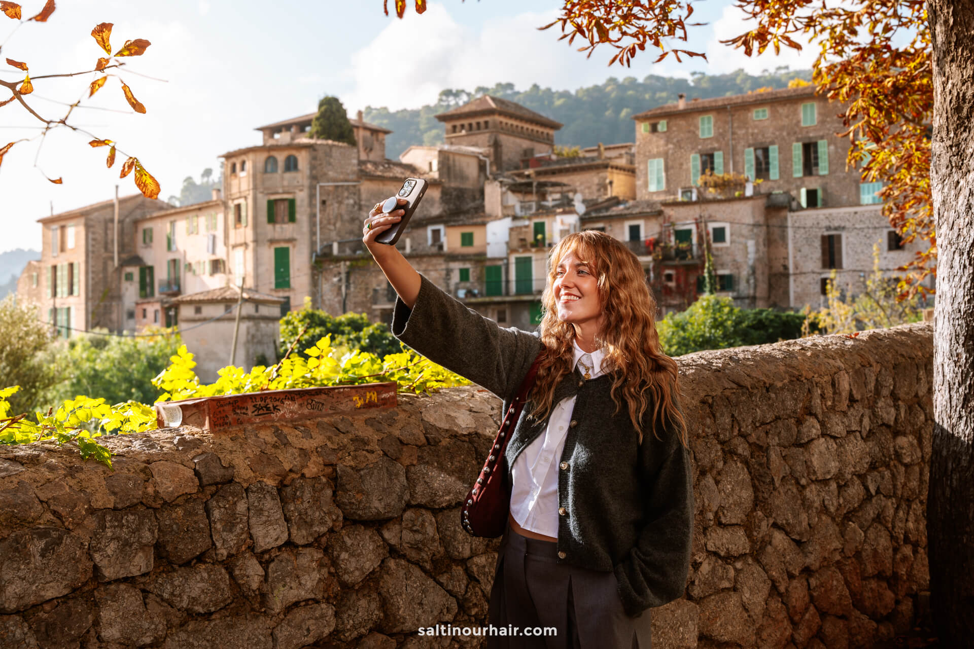 blogging tools using social media filming herself with phone in european village