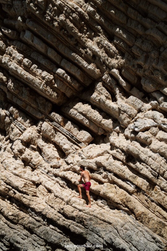 man cliff jumping corfu