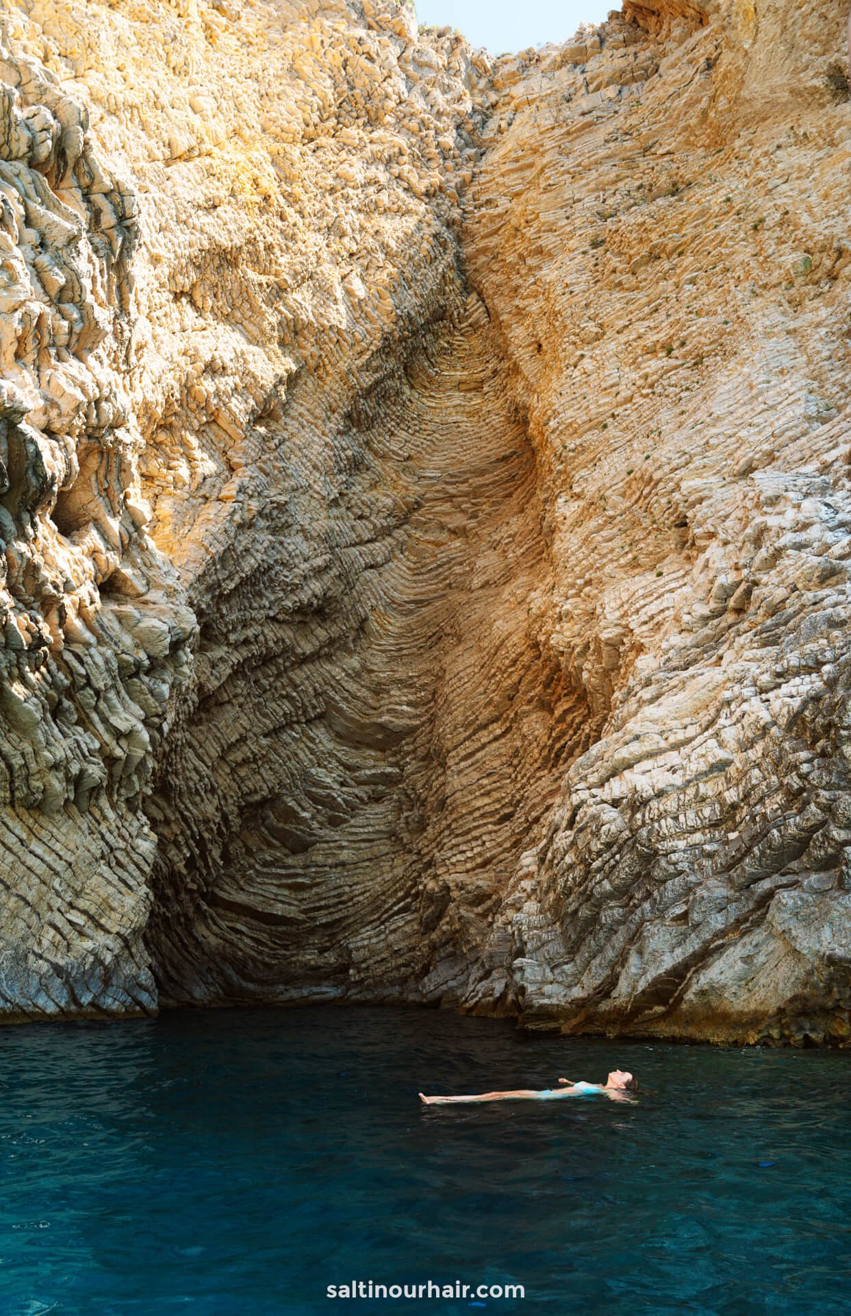 woman swimming in cave corfu greece