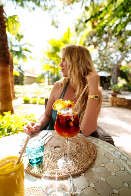 woman at Santanyi Mallorca Market enjoying a cocktail in outdoor restaurant