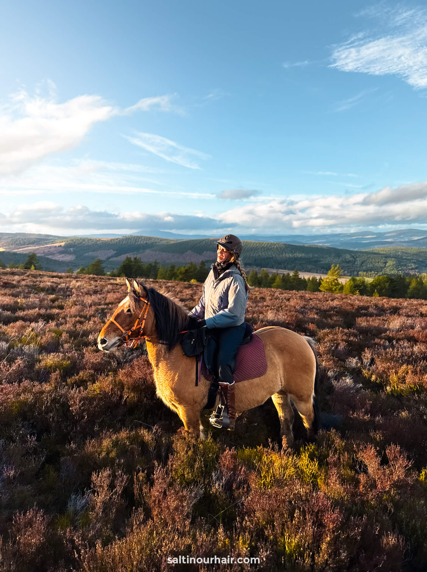 happy woman horseback riding scotland