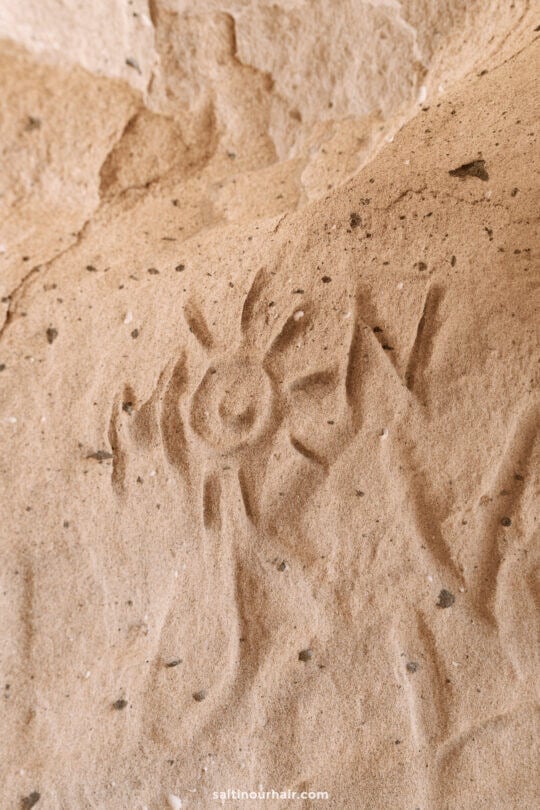 Petroglyph of a sun-like figure carved into a rough, beige rock surfaceâ€”a fascinating glimpse into ancient Porto Santo, perfect for history enthusiasts seeking unique things to do in Porto Santo.