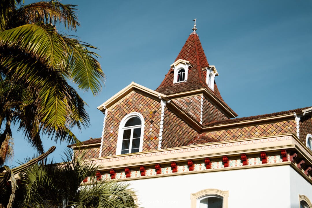 A building with a red-tiled roof and tower, white walls, and decorative trim is one of the charming sights among the many things to do in S&atilde;o Miguel.