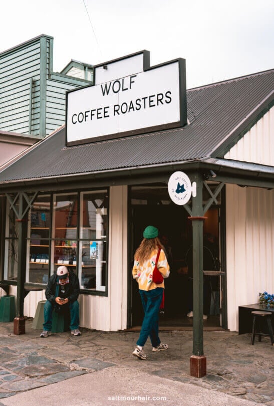 A woman enters Wolf Coffee Roasters in arrow town, one of the top things to do in Queenstown